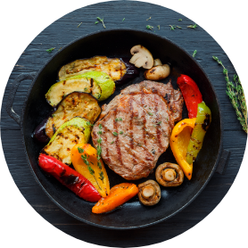 Grilled-beef-steak-on-dark-wooden-table-background-top-view.png